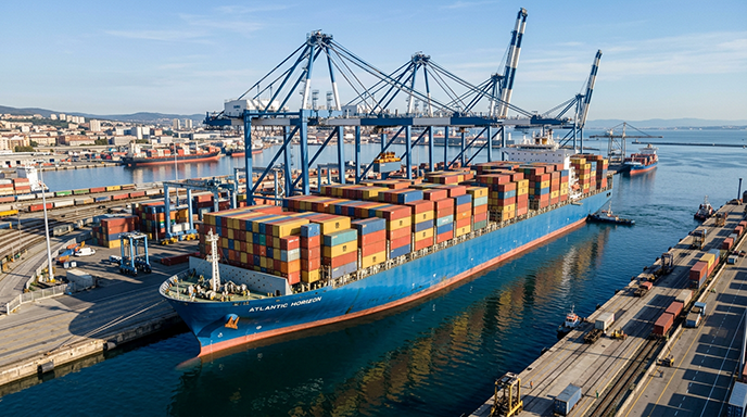 Loaded container ship berthed under gantry cranes at a European port